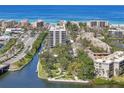 Aerial view of a beautiful coastal community featuring lush landscaping and waterway access at 6415 Midnight Pass Rd # 502, Sarasota, FL 34242