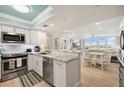 Bright, open kitchen with granite countertops and stainless steel appliances overlooking the dining and living areas at 6415 Midnight Pass Rd # 502, Sarasota, FL 34242