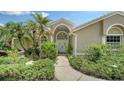 Inviting front entrance with elegant double doors and lush greenery at 8239 Cypress Hollow Dr, Sarasota, FL 34238