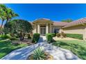 Home's front entrance with manicured shrubs and a pathway leading to double doors with decorative glass at 8315 Eagle Xing, Sarasota, FL 34241