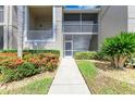 Inviting condo exterior with manicured landscaping and screened-in lanai at 9580 High Gate Dr # 1822, Sarasota, FL 34238