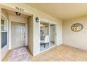 Cozy covered patio featuring tile flooring, chandelier, and sliding glass door at 9580 High Gate Dr # 1822, Sarasota, FL 34238