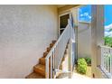 Exterior staircase with tile steps and white railings to the condo's entrance at 9580 High Gate Dr # 1822, Sarasota, FL 34238
