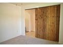 Bedroom featuring a decorative wooden sliding door at 10019 Geese Trail Cir, Sun City Center, FL 33573