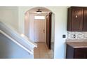 Inviting entryway featuring tiled floors, an archway, and a sliding barn door at 10019 Geese Trail Cir, Sun City Center, FL 33573