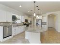 Bright kitchen with a large island, stainless steel appliances, and white cabinetry providing ample storage space at 11221 Sandhill Preserve Dr, Sarasota, FL 34238