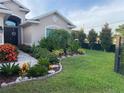 Beautiful home exterior showcasing lush landscaping and a well-manicured lawn at 12398 Keyridge Loop, Largo, FL 33778