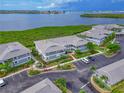 Aerial view showcases the condo community near lush greenery and a body of water at 1319 Perico Point Cir, Bradenton, FL 34209