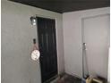 Close-up of front door entrance with light fixture and doorbell at 1423 17Th E Ave, Bradenton, FL 34208