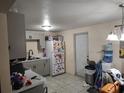 Functional kitchen space with gray cabinets and white appliances at 1423 17Th E Ave, Bradenton, FL 34208
