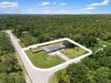 Expansive aerial view of a well-maintained home surrounded by lush greenery at 17211 Drayton Ln, Port Charlotte, FL 33948