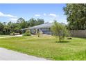 Charming single-story home with a well-manicured lawn and mature landscaping at 17211 Drayton Ln, Port Charlotte, FL 33948