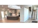 Open-concept kitchen features a large island, modern stainless steel appliances, and brick backsplash at 2110 Michele Dr, Sarasota, FL 34231