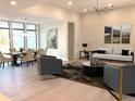 Bright and open living space with modern furnishings, art, and a dining area at 2110 Michele Dr, Sarasota, FL 34231