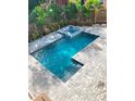 Inviting pool and hot tub surrounded by brick pavers and lush tropical landscaping at 2110 Michele Dr, Sarasota, FL 34231