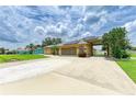 Lovely home with an extended driveway, well-maintained lawn, and solar panels at 23136 Langdon Ave, Port Charlotte, FL 33954