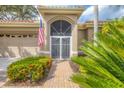 Inviting front entrance with secure gate, brick pathway and lush landscaping at 2518 Dick Wilson Dr, Sarasota, FL 34240