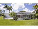 Inviting screened-in pool and backyard area featuring landscaping and plenty of space for outdoor enjoyment at 3167 Pinetree St, Port Charlotte, FL 33952