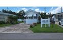 Inviting single-story home with a well-kept lawn and a neatly paved driveway on a sunny day at 3333 26Th E Ave # 1023, Bradenton, FL 34208