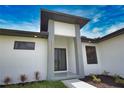 Contemporary home showcasing a modern entryway with double doors and decorative exterior lights at 350 Bucknell Rd, Venice, FL 34293