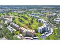View of condo building surrounded by green golf course at 3640 Ironwood Cir # 302N, Bradenton, FL 34209
