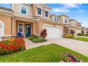 Inviting townhome with a brick driveway, blue accent chair, and well-manicured landscaping at 3673 Fescue Ln, Sarasota, FL 34232