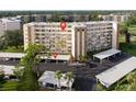 View of condo building showing parking and surrounding trees at 3680 Ironwood Cir # 603L, Bradenton, FL 34209