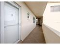 Hallway with a white door, tile floors, and windows allowing natural light to enter the building at 3680 Ironwood Cir # 603L, Bradenton, FL 34209