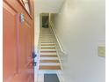 Entryway with wooden stairs leading to the upper level of the home at 5001 Baraldi Cir # 22-202, Sarasota, FL 34235