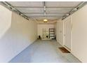 Spacious one car garage with painted floor and white walls at 5001 Baraldi Cir # 22-202, Sarasota, FL 34235