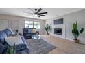 Bright living room with large window, fireplace, and modern furnishings creates an inviting atmosphere at 5032 Barcelona Ave, Sarasota, FL 34235