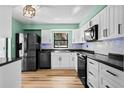 Modern kitchen featuring stainless steel appliances, white cabinets, and tile backsplash at 6061 Fairway Ln # 1411, Bradenton, FL 34210