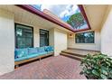Cozy brick-paved front porch with comfortable seating, perfect for relaxing at 6111 Courtside Dr # 61, Bradenton, FL 34210