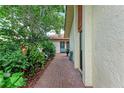 Charming front walkway lined with lush plants leading to the front of the home at 6111 Courtside Dr # 61, Bradenton, FL 34210