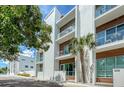 Modern condo building with sleek design, balconies, and street view at 626 Rawls Ave # 626, Sarasota, FL 34236