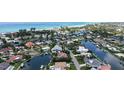 Breathtaking aerial view of a waterfront property featuring a private pool and boat dock with stunning ocean views at 670 Old Compass Rd, Longboat Key, FL 34228