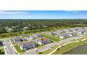 Birds eye view of the property, neighborhood, with lush green surroundings and an inviting lake nearby at 7352 Cabin Ln, Sarasota, FL 34240