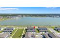 Wide aerial view showcasing the community, nearby lake, and the property with ample parking space at 7352 Cabin Ln, Sarasota, FL 34240