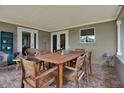 Inviting covered patio with a brick floor and comfortable wooden outdoor furniture at 7404 14Th W Ave, Bradenton, FL 34209