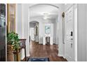 Elegant hallway featuring beautiful archways, wood floors, neutral walls, and decor at 7747 33Rd E St, Sarasota, FL 34243