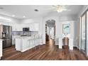 Bright kitchen featuring white cabinets, stainless steel appliances, hardwood floors, and an open layout at 7747 33Rd E St, Sarasota, FL 34243