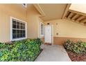 Inviting entrance with window and trimmed hedges, creating a warm and welcoming appeal at 1030 Villagio Cir # 103, Sarasota, FL 34237