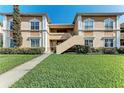 Two-story exterior with well-manicured lawn and inviting entryway, great for curb appeal at 1030 Villagio Cir # 103, Sarasota, FL 34237