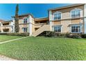 Two-story exterior with well-manicured lawn and inviting entryway, great for curb appeal at 1030 Villagio Cir # 103, Sarasota, FL 34237