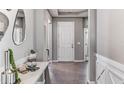 Inviting entryway with tiled floors, a console table, and modern decor at 10721 Tippecanoe Pl, Parrish, FL 34219