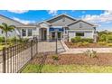 Attractive home with a landscaped front yard, stone accents, and covered entry at 10721 Tippecanoe Pl, Parrish, FL 34219