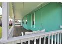 Inviting porch with a charming white swing, perfect for relaxing outdoors at 12107 45Th W Ave, Cortez, FL 34215