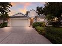 Charming two-story home with a well-maintained lawn, a neutral stucco exterior, and a two-car garage at 1245 Millbrook Cir, Bradenton, FL 34212