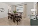 Bright dining room featuring stylish chairs, neutral paint, tile floors and natural light from window at 15336 Serene Shores Loop, Bradenton, FL 34211