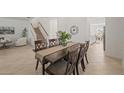 Stylish dining room adjacent to a staircase, featuring modern furniture, neutral paint, and tile floors at 15336 Serene Shores Loop, Bradenton, FL 34211